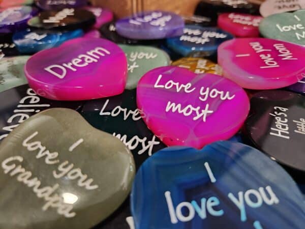 Pile of engraved hearts with a variety of I love you quotes