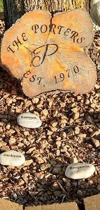 Small name rocks in front of family front yard tree. With wood engraving that says, the Porters