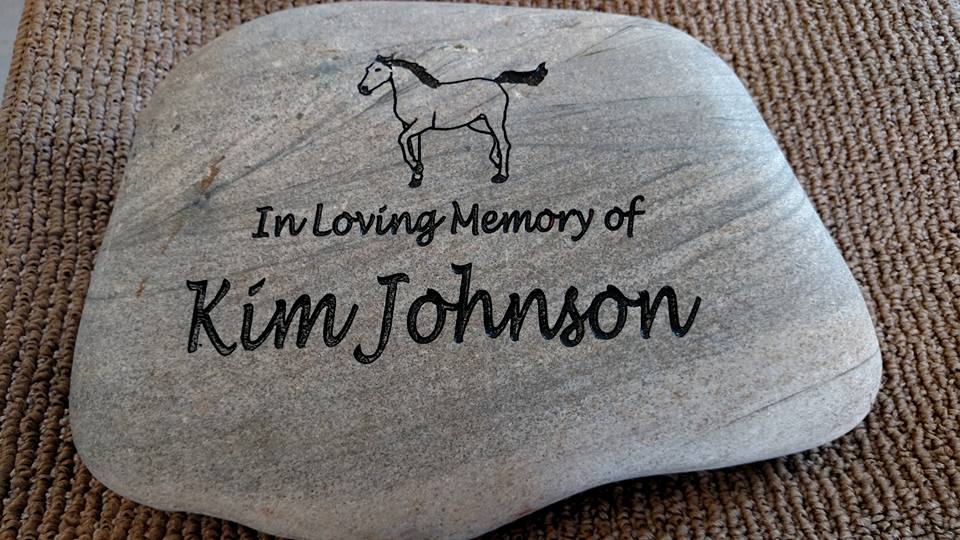 Small pet memorial that has graphic of a horse and text, in loving memory of Kim Johnson.