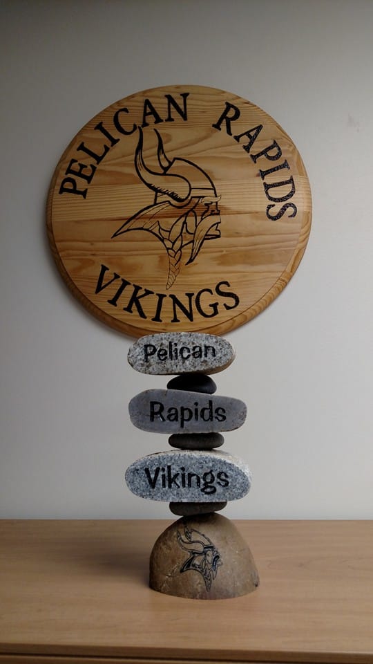 Custom three tier stacker that says from top to bottom Pelican, rapids, Vikings. With the NFL Vikings logo engraved at the bottom.