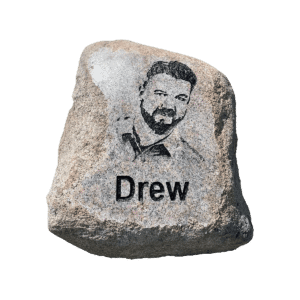large engraved custom rock with the text Drew and a image of him