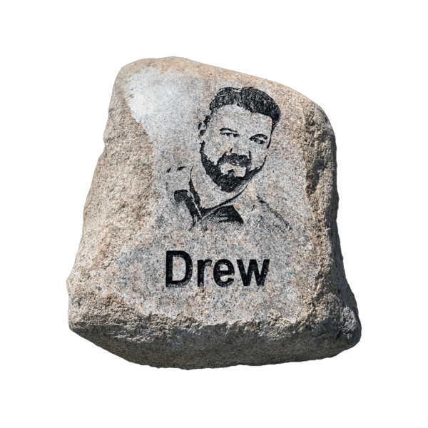 large engraved custom rock with the text Drew and a image of him