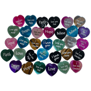 Engraved hearts in colors pink, blue, green, black, purple, and white. Most engraved with I love you.
