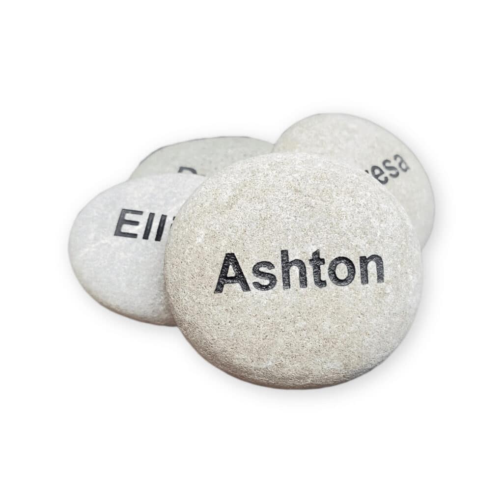 White name rocks, front rock has the name Ashton engraved on it