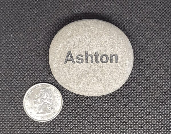 Name Rocks White name rock that says ashton next to a quarter. The quarter is a fourth of the size of the engraved rock.