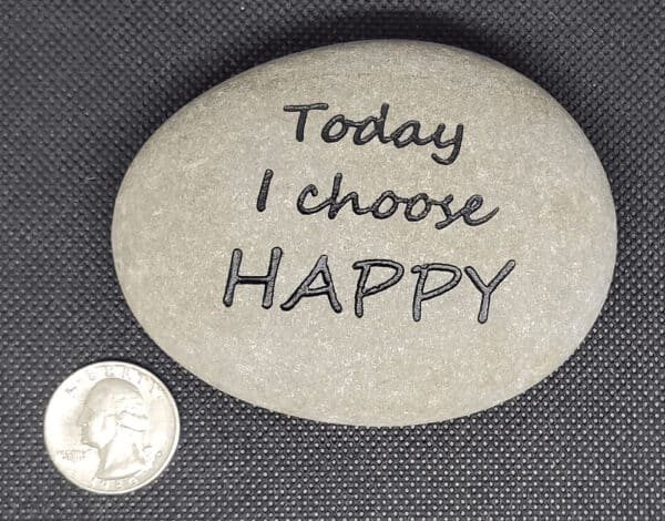 Phrase rock with engraving today I choose Happy next to a quarter. The quarter is an eighth of the size of the rock