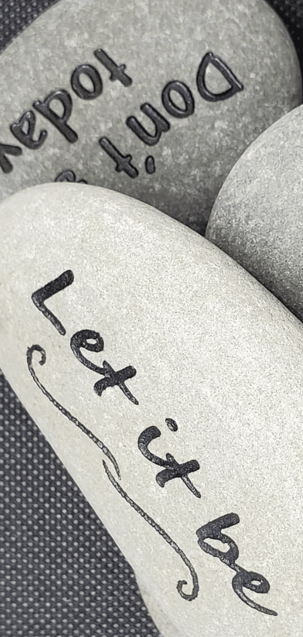 Small engraved rocks with text, let it be, dont suck today