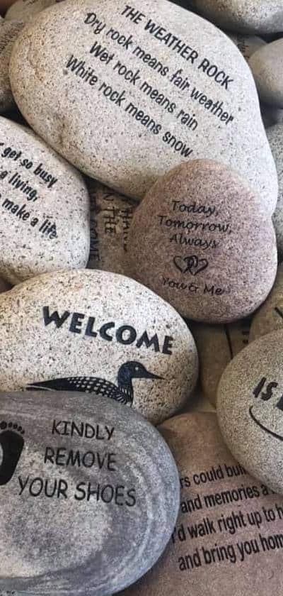 A large number of engraved stones with various designs and text. Every rock has a story.