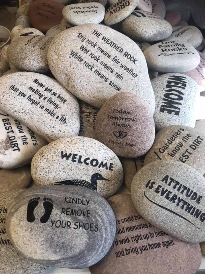 A large number of engraved stones with various designs and text. Every rock has a story.