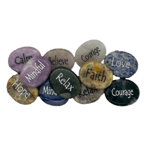 Round shaped engraved worry stones in colors pink, blue, green, yellow, purple, and white. Engraved with words like Relax, Calm, Courage, hope.