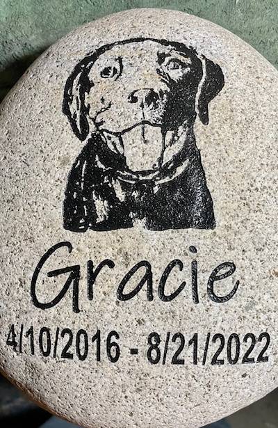 Engraved pet memorial with text Gracie 04/10/2026 - 08/21/2022 with a custom graphic of the dog