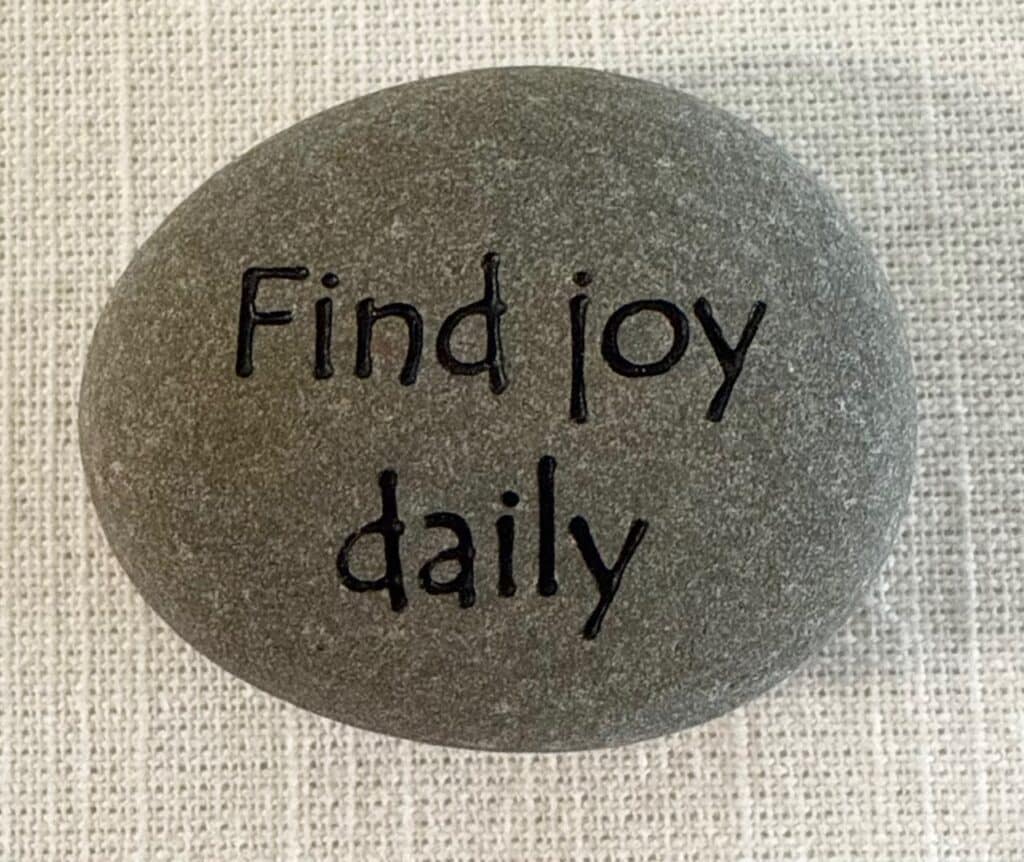 Inspirational stones - stone with find joy daily engraved on it.