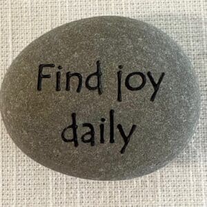 Inspirational stones - stone with find joy daily engraved on it.