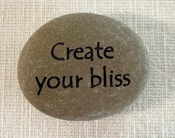 Inspirational stones - stone with Create your bliss engraved on it.